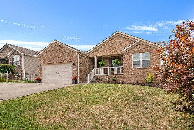 view of front of house with a porch, a garage, and a front yard