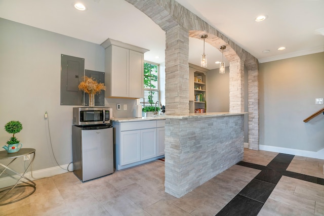 kitchen featuring light tile patterned floors, refrigerator, electric panel, decorative light fixtures, and gray cabinetry