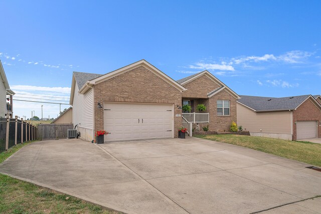 view of front of home featuring a garage and central air condition unit