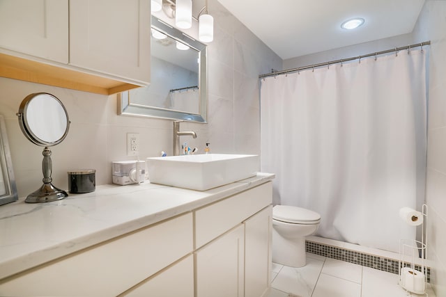 bathroom featuring tile patterned flooring, tile walls, toilet, and vanity