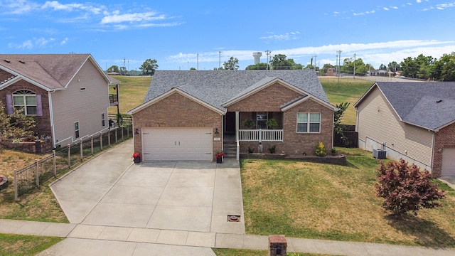 ranch-style home with a porch, central AC unit, a garage, and a front lawn