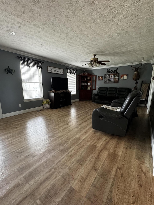 unfurnished living room with ceiling fan, hardwood / wood-style floors, and a textured ceiling