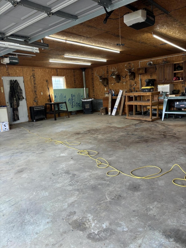 garage with a workshop area and a garage door opener