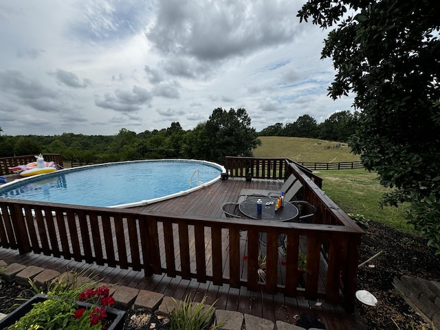 view of pool featuring a wooden deck and a rural view