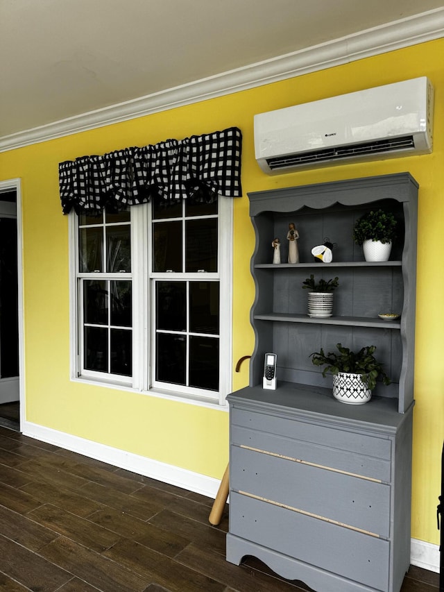 interior space featuring an AC wall unit, crown molding, and wood-type flooring