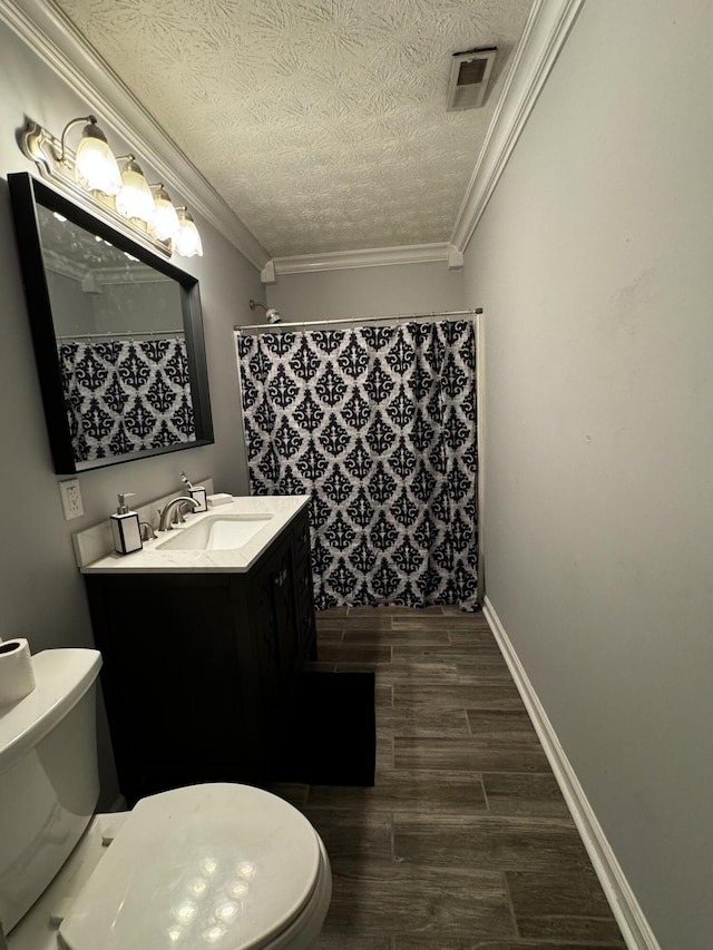 bathroom with ornamental molding, a shower with curtain, vanity, a textured ceiling, and toilet