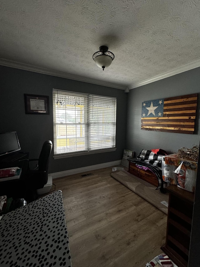 office featuring hardwood / wood-style flooring, crown molding, and a textured ceiling