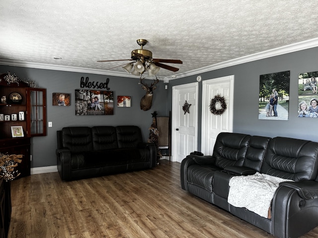 living room featuring ceiling fan, wood-type flooring, ornamental molding, and a textured ceiling