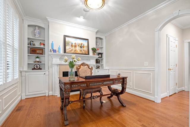 office area with light hardwood / wood-style flooring, ornamental molding, and built in features