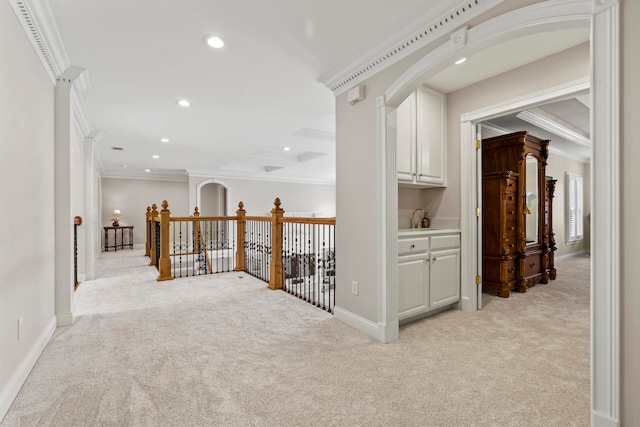 hallway featuring crown molding and light colored carpet