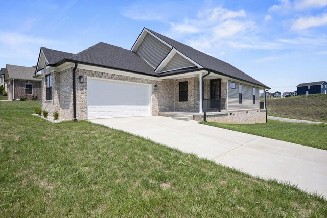 view of front of home featuring a porch, a garage, and a front lawn