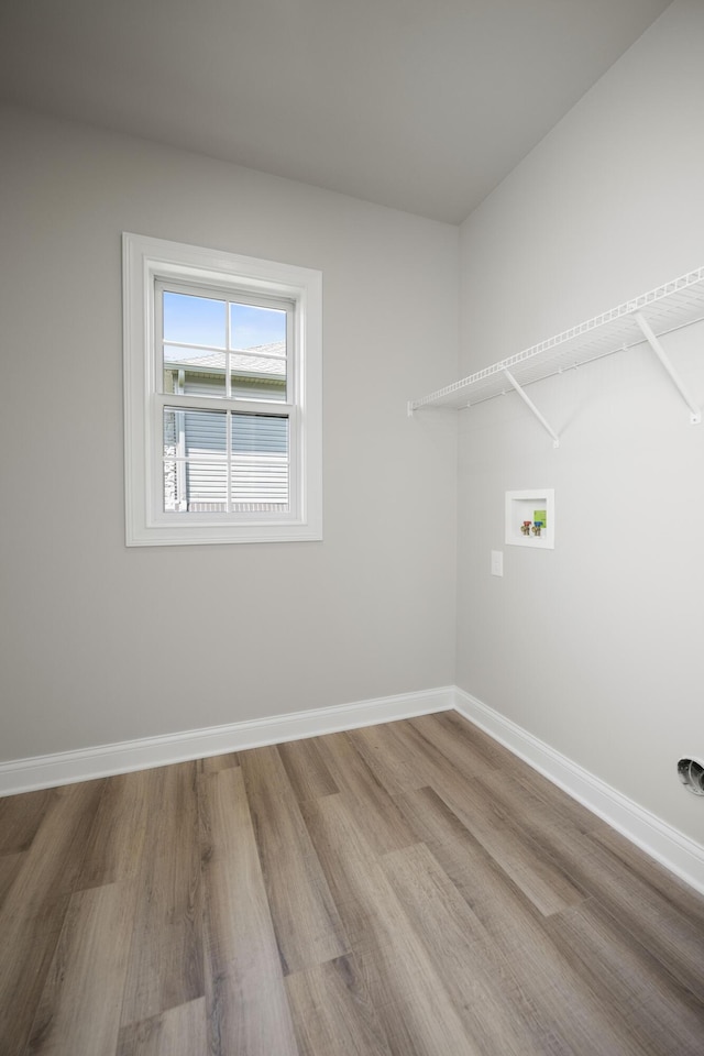 laundry room featuring washer hookup and light hardwood / wood-style flooring