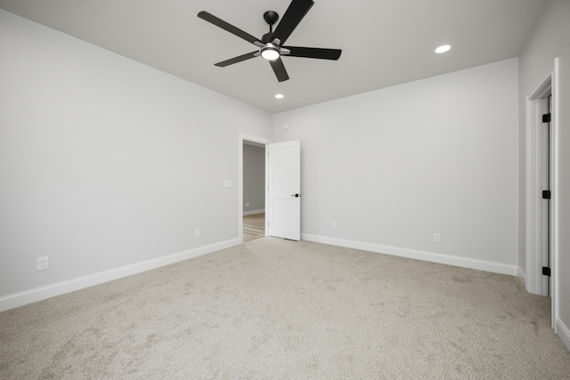 unfurnished bedroom featuring ceiling fan and light carpet