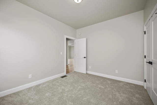 unfurnished bedroom featuring light colored carpet