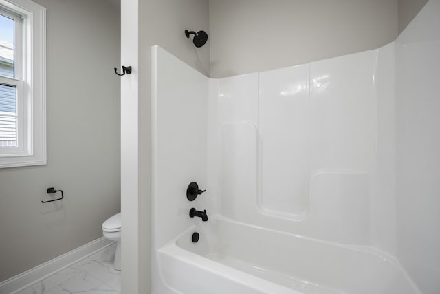 bathroom with tub / shower combination and toilet