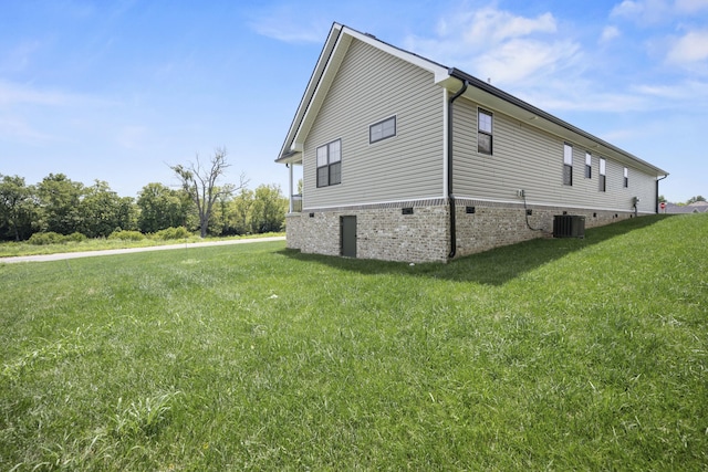 view of home's exterior with a yard and central air condition unit