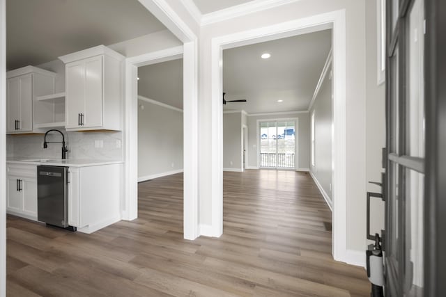 bar featuring white cabinetry, dishwasher, ceiling fan, and light hardwood / wood-style floors