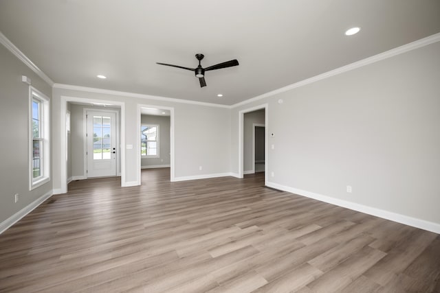 unfurnished living room with crown molding, ceiling fan, and light hardwood / wood-style flooring