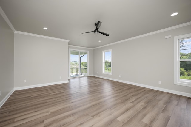 empty room with ceiling fan, ornamental molding, and light hardwood / wood-style flooring