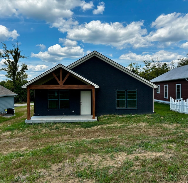 back of property with a patio and a lawn