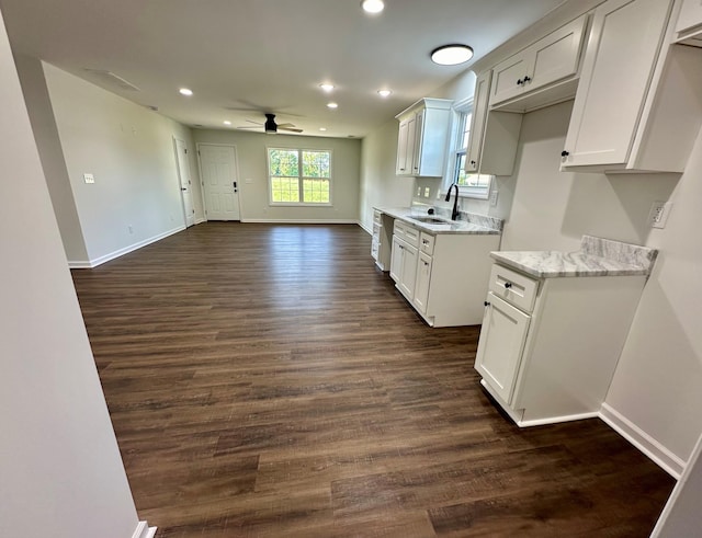 kitchen with sink, white cabinetry, dark wood-type flooring, and ceiling fan