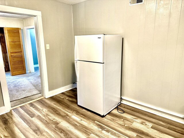 kitchen featuring light hardwood / wood-style floors and white fridge