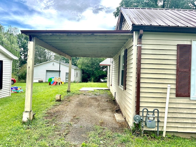 view of property exterior with a garage, a yard, a carport, and an outdoor structure