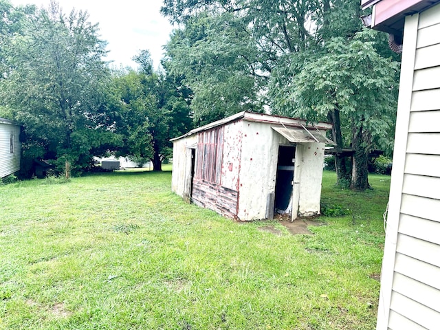 view of outbuilding with a yard