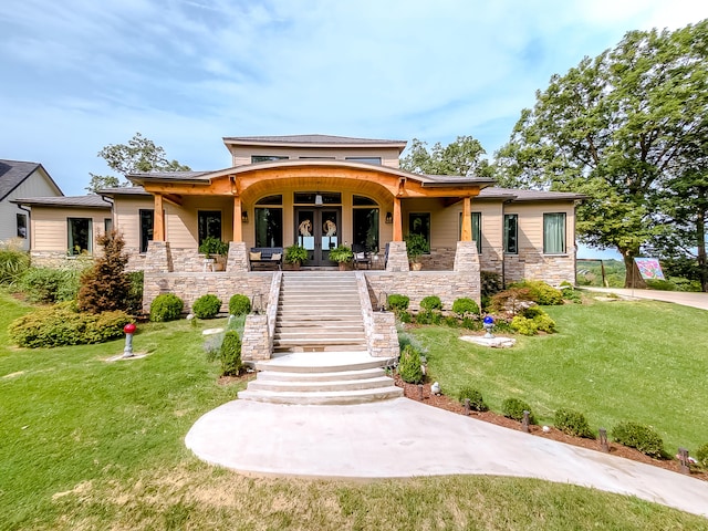 prairie-style house featuring a front lawn and covered porch