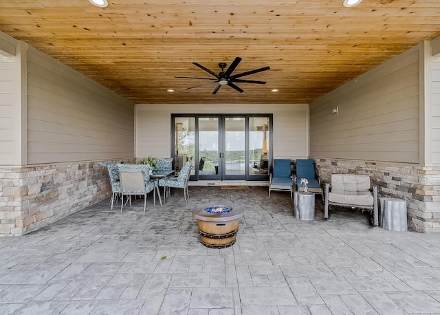 view of patio featuring french doors, ceiling fan, and an outdoor fire pit