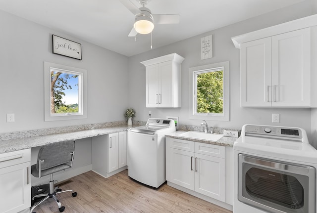 clothes washing area featuring sink, cabinets, ceiling fan, light hardwood / wood-style floors, and washing machine and dryer