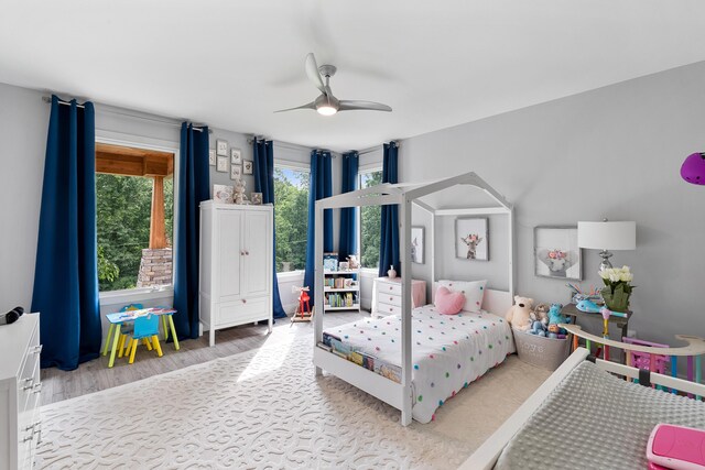 bedroom with light hardwood / wood-style flooring and ceiling fan