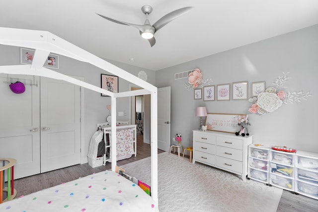 bedroom featuring ceiling fan, wood-type flooring, and a closet