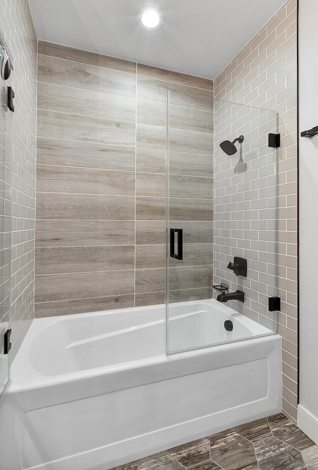 bathroom with tiled shower / bath combo and tile patterned floors