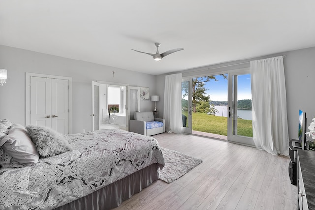 bedroom featuring access to outside, light wood-type flooring, ceiling fan, and a closet