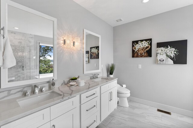 bathroom featuring dual vanity, a shower with door, tile patterned flooring, and toilet