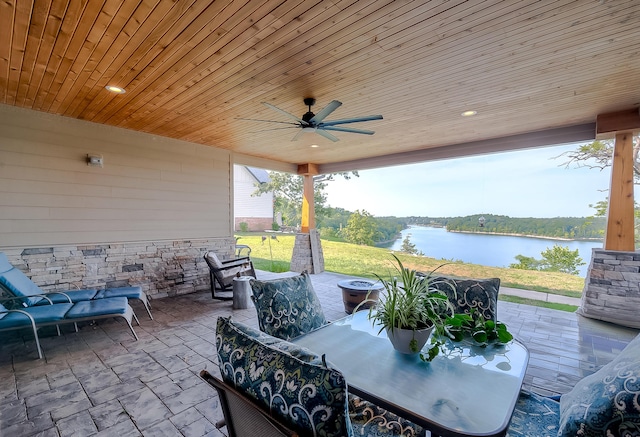 view of patio / terrace with ceiling fan and a water view