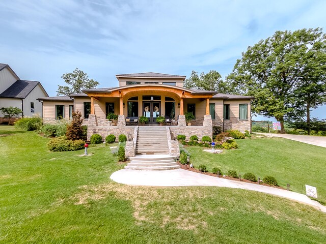 prairie-style house featuring a porch and a front lawn