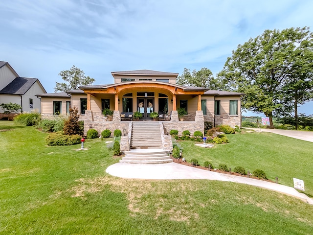 prairie-style home with french doors, covered porch, and a front yard