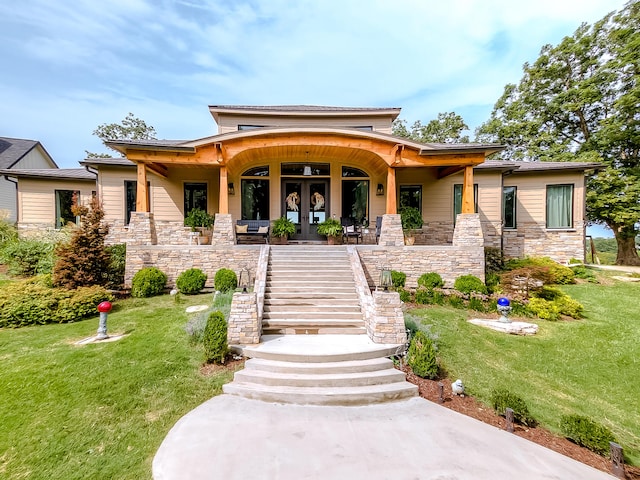 view of front of house with a porch and a front lawn