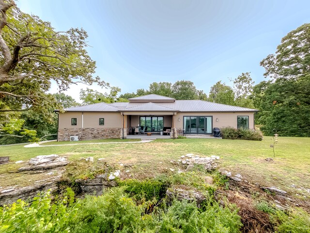 back of house featuring a patio and a lawn