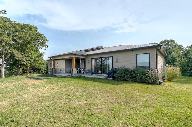 back of house with a patio and a yard