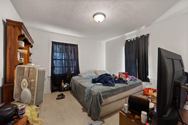 106 18th St, Corbin, KY 40701 - tiled bedroom with a textured ceiling