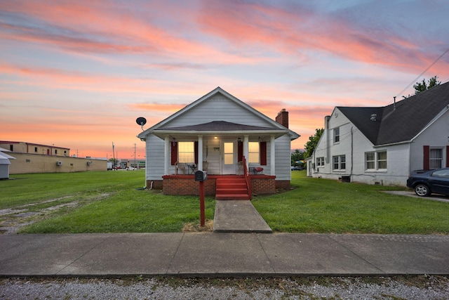 106 18th St, Corbin, KY 40701 - bungalow-style home featuring a porch and a yard
