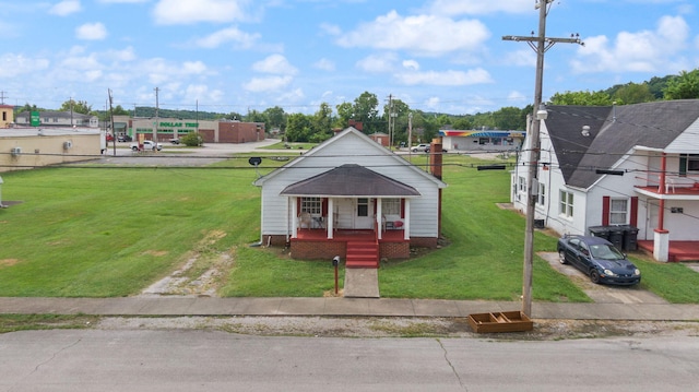 106 18th St, Corbin, KY 40701 - bungalow-style home featuring a porch and a front lawn