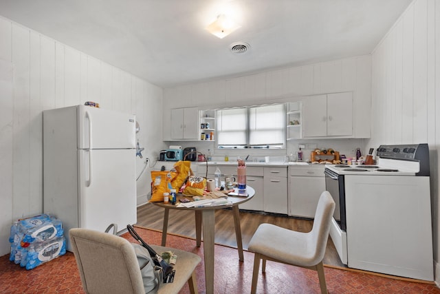 106 18th St, Corbin, KY 40701 - kitchen featuring wood walls and white appliances
