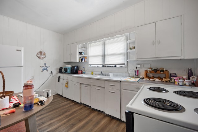 106 18th St, Corbin, KY 40701 - kitchen with range, sink, white cabinetry, dark wood-type flooring, and white fridge