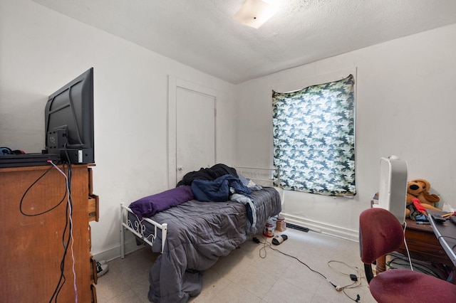106 18th St, Corbin, KY 40701 - tiled bedroom featuring a textured ceiling