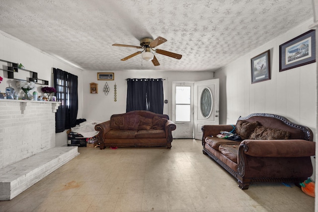 106 18th St, Corbin, KY 40701 - tiled living room featuring a textured ceiling, ceiling fan, and a brick fireplace
