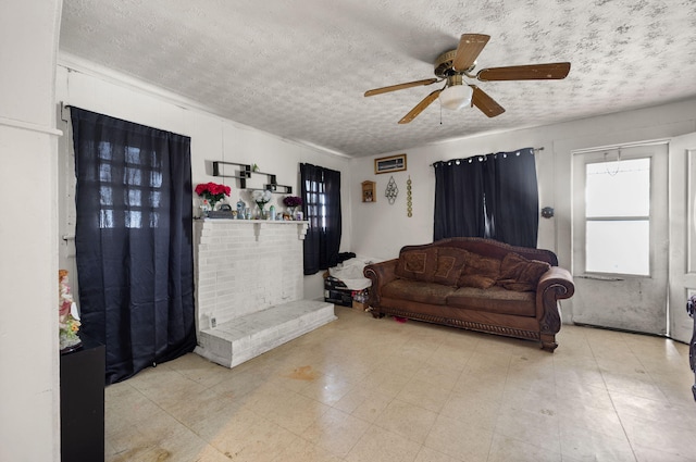 106 18th St, Corbin, KY 40701 - living room featuring a textured ceiling, a brick fireplace, light tile patterned floors, and ceiling fan